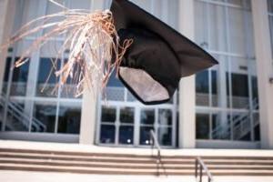 A graduation mortarboard in the air.